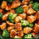 Crockpot Teriyaki Chicken in a bowl garnished with sesame seeds and green onions